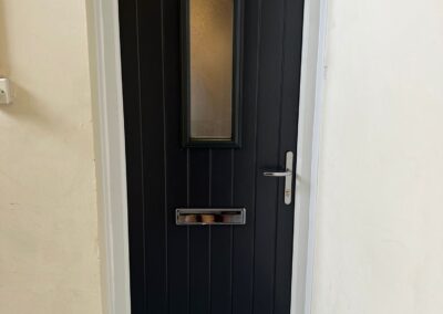 Black composite door in a white frame - Glazerite uPVC