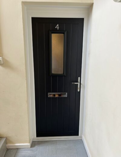 Black composite door in a white frame - Glazerite uPVC