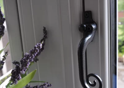 Close up photo of a hammered black monkey tail style window handle - Glazerite uPVC