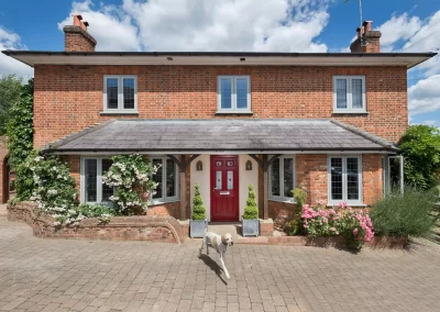 Property with new red composite entrance door and agate grey flush casement windows - Glazerite uPVC