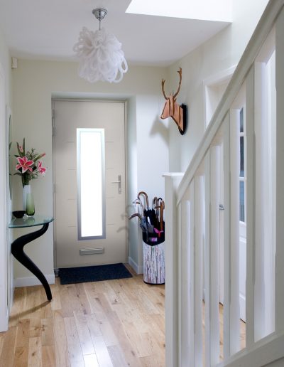 View of a hallway with a Smart Aluminium Designer Door - Glazerite uPVC