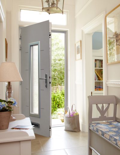 Bag of flowers next to a grey Smart Aluminium Designer Door - Glazerite uPVC