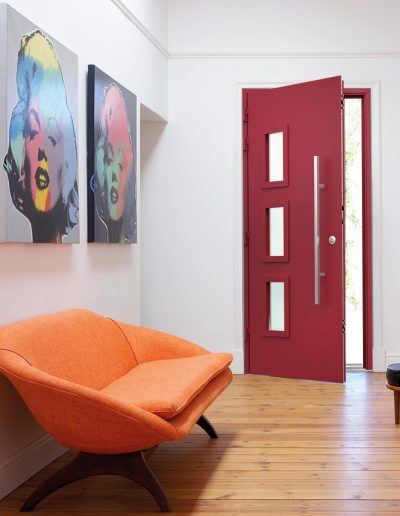 Home with colourful artwork and a red Smart Aluminium Designer Door - Glazerite uPVC