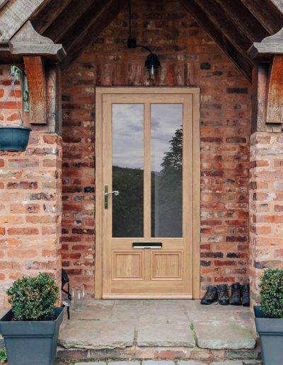 Red brick house with a composite door in Irish oak - Glazerite UPVC